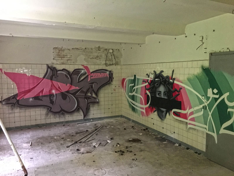 Großflächige Grafitti in einem niedrigen Raum der ehemaligen Wäscherei der Landesirrenanstalt Teupitz, Brandenburg, südlich von Berlin - Lost Places